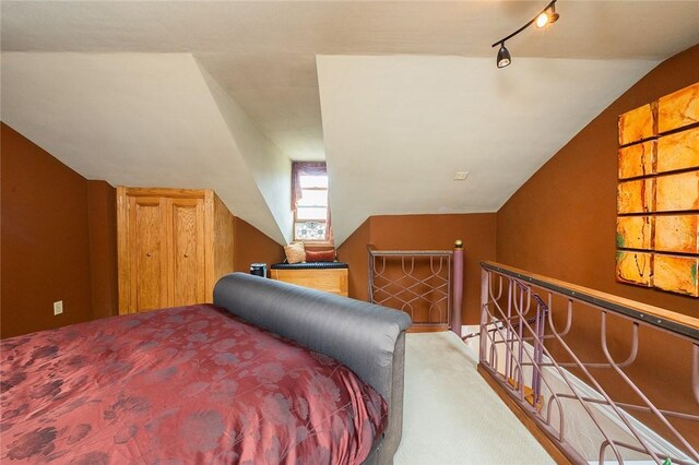 2220 Sarah St, South Side, PA 15203 - bedroom featuring carpet floors, vaulted ceiling, and track lighting