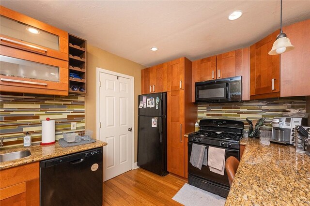 2220 Sarah St, South Side, PA 15203 - kitchen with black appliances, brown cabinetry, decorative backsplash, light wood-type flooring, and recessed lighting