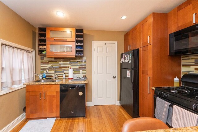 2220 Sarah St, South Side, PA 15203 - kitchen featuring black appliances, a sink, light wood-style floors, brown cabinets, and recessed lighting