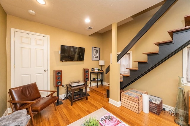 2220 Sarah St, South Side, PA 15203 - living area featuring light wood-type flooring, stairs, baseboards, and recessed lighting