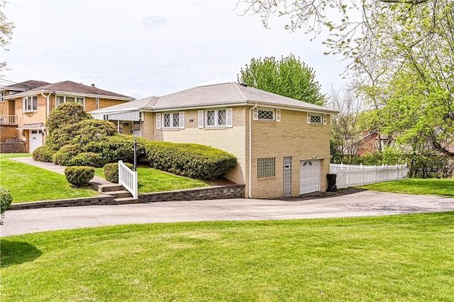 1079 Hedy Lynn Dr, North Huntingdon, PA 15642 - rear view of property with driveway, a garage, and brick siding