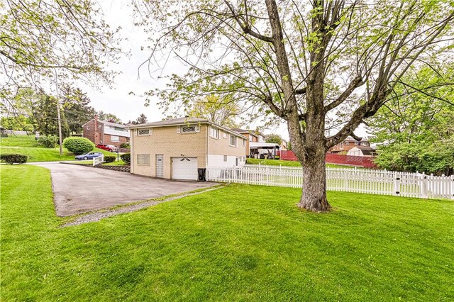 1079 Hedy Lynn Dr, North Huntingdon, PA 15642 - view of yard featuring driveway and a garage