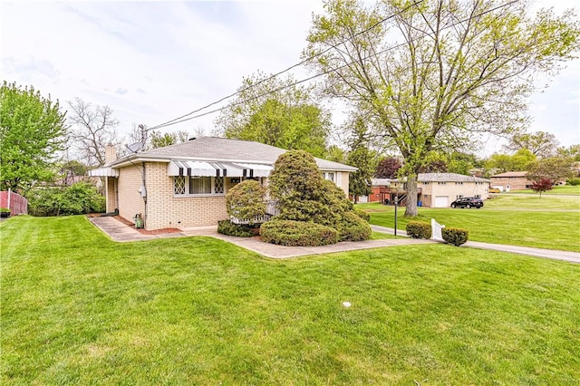 1079 Hedy Lynn Dr, North Huntingdon, PA 15642 - view of front of property with brick siding, a front yard, and a chimney