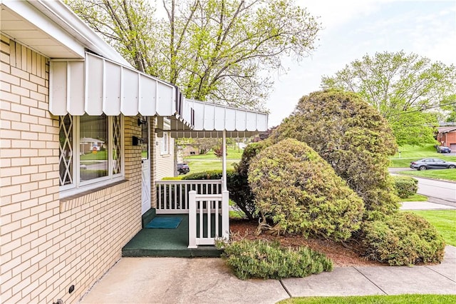 1079 Hedy Lynn Dr, North Huntingdon, PA 15642 - view of property exterior featuring brick siding, board and batten siding, and a porch