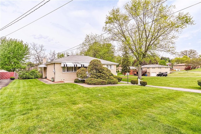 1079 Hedy Lynn Dr, North Huntingdon, PA 15642 - view of front of house with a front lawn, a chimney, and brick siding