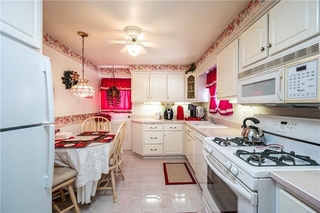 1079 Hedy Lynn Dr, North Huntingdon, PA 15642 - kitchen with white appliances, light countertops, a ceiling fan, a sink, and white cabinets