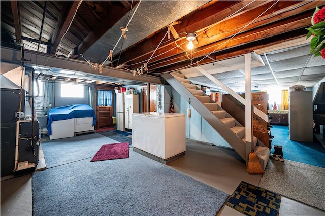 1079 Hedy Lynn Dr, North Huntingdon, PA 15642 - basement featuring heating unit, stairway, and refrigerator
