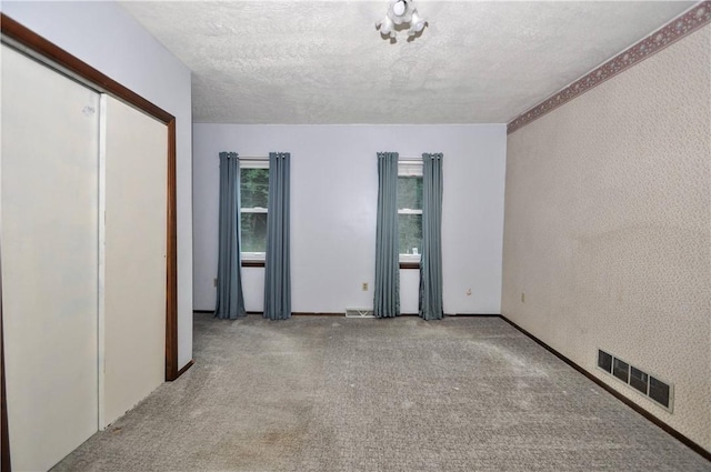 3053 Scheinbach Rd, Jefferson Hills, PA 15332 - unfurnished bedroom featuring carpet, a textured ceiling, a closet, and baseboards