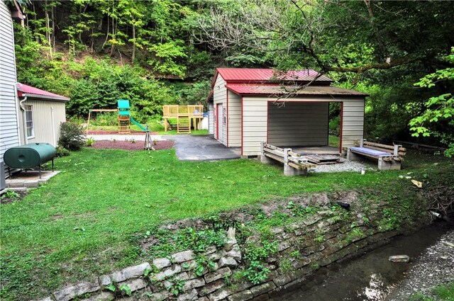 3053 Scheinbach Rd, Jefferson Hills, PA 15332 - view of green lawn with an outdoor structure, oil tank, and a detached garage