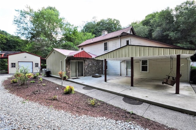 3053 Scheinbach Rd, Jefferson Hills, PA 15332 - rear view of property with an outbuilding, a chimney, and stone siding