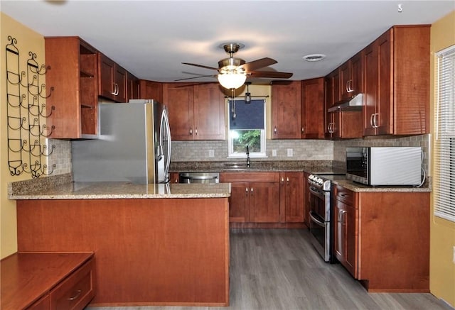 3053 Scheinbach Rd, Jefferson Hills, PA 15332 - kitchen with stainless steel appliances, ceiling fan, wood finished floors, a sink, and under cabinet range hood