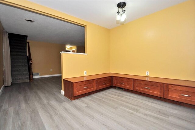 3053 Scheinbach Rd, Jefferson Hills, PA 15332 - spare room featuring light wood-style flooring, stairway, and baseboards