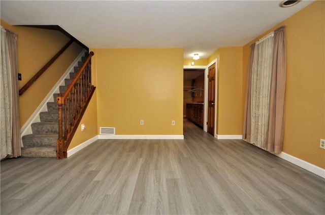 3053 Scheinbach Rd, Jefferson Hills, PA 15332 - unfurnished living room featuring wood finished floors, stairs, and baseboards