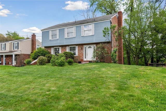 179 Kelvington Dr, Monroeville, PA 15146 - colonial-style house with a chimney, a front lawn, brick siding, and entry steps