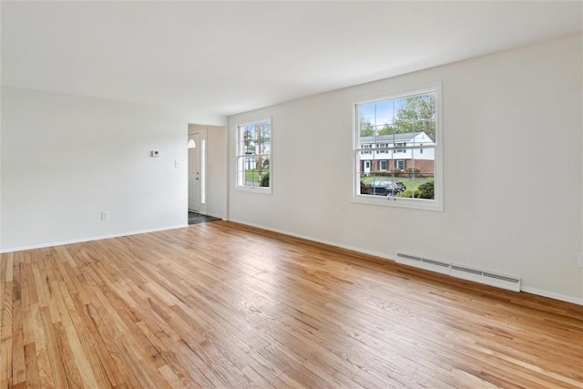 179 Kelvington Dr, Monroeville, PA 15146 - unfurnished living room with baseboard heating, light wood finished floors, and baseboards