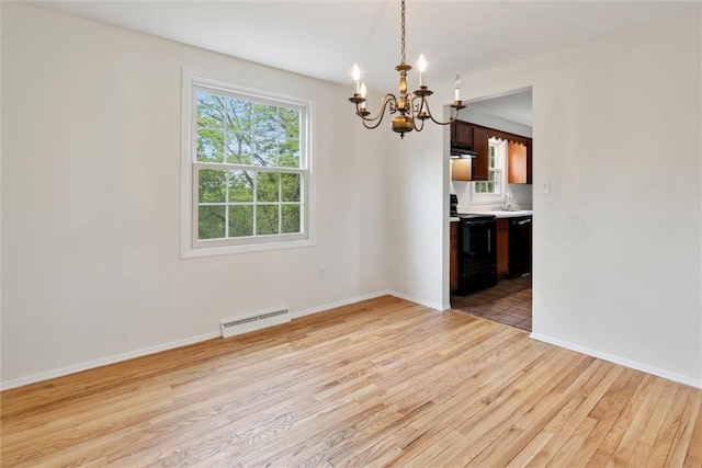 179 Kelvington Dr, Monroeville, PA 15146 - unfurnished dining area with a chandelier, light wood-style floors, a sink, baseboard heating, and baseboards