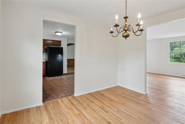 179 Kelvington Dr, Monroeville, PA 15146 - unfurnished dining area with a chandelier, light wood-style flooring, and baseboards