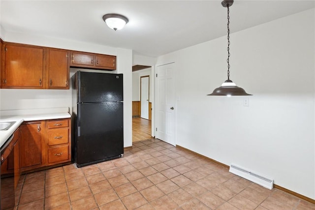 179 Kelvington Dr, Monroeville, PA 15146 - kitchen with freestanding refrigerator, light countertops, brown cabinets, and decorative light fixtures
