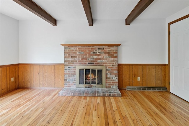 179 Kelvington Dr, Monroeville, PA 15146 - unfurnished living room with wainscoting, beam ceiling, hardwood / wood-style flooring, wooden walls, and a fireplace