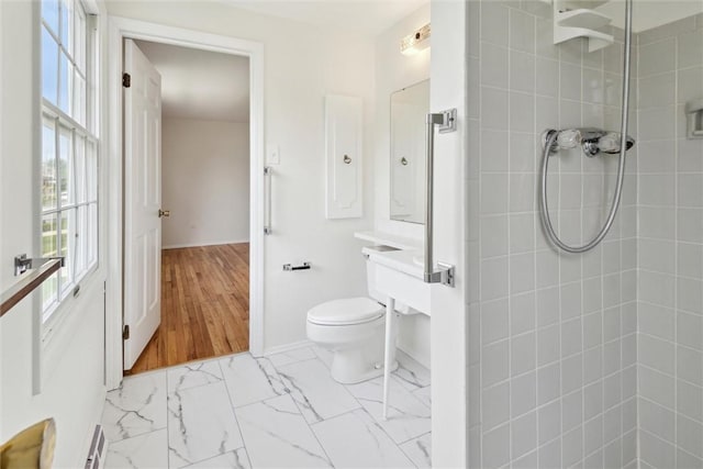 179 Kelvington Dr, Monroeville, PA 15146 - bathroom featuring a tile shower, toilet, baseboards, and marble look tiles