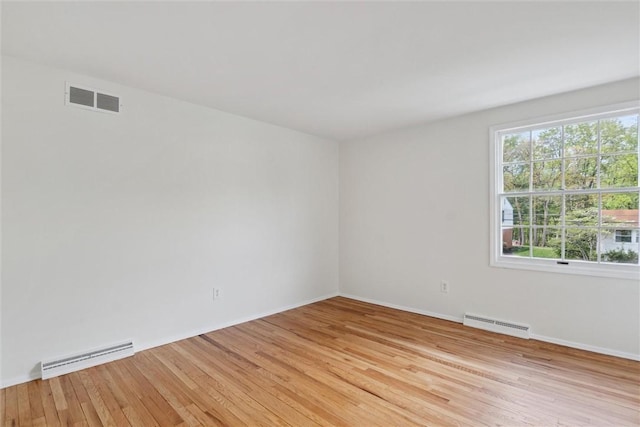 179 Kelvington Dr, Monroeville, PA 15146 - empty room with light wood-style flooring, baseboards, and a baseboard radiator