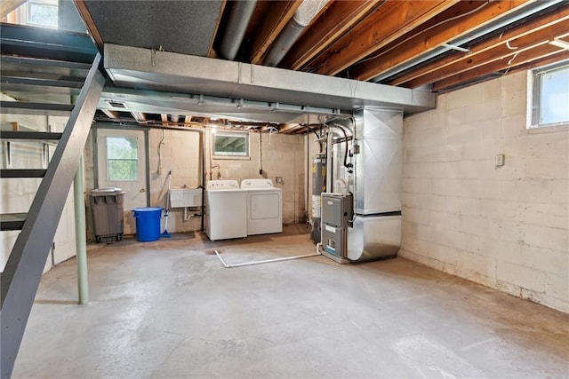 179 Kelvington Dr, Monroeville, PA 15146 - basement featuring washing machine and dryer, heating unit, a sink, and plenty of natural light