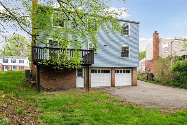 179 Kelvington Dr, Monroeville, PA 15146 - rear view of property with central AC, an attached garage, driveway, brick siding, and a deck