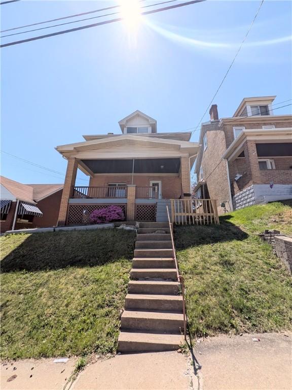330 Quincy Ave, Mount Oliver, PA 15210 - view of front of property with covered porch, a front lawn, and stairs