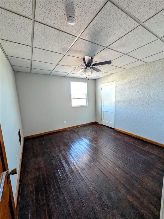 330 Quincy Ave, Mount Oliver, PA 15210 - unfurnished room with hardwood / wood-style floors, a paneled ceiling, baseboards, a smoke detector, and a ceiling fan