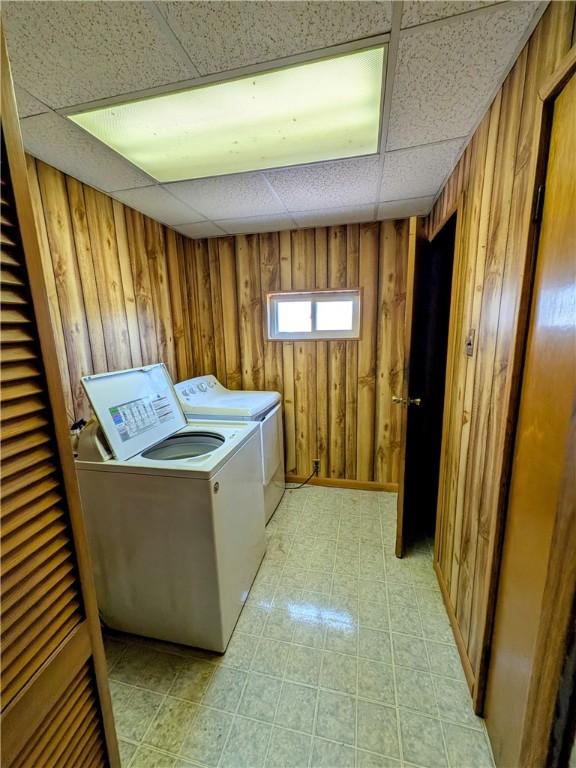 330 Quincy Ave, Mount Oliver, PA 15210 - laundry area featuring wood walls, washer and clothes dryer, and light floors