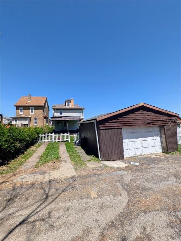 330 Quincy Ave, Mount Oliver, PA 15210 - view of front of house with a garage, an outdoor structure, and fence