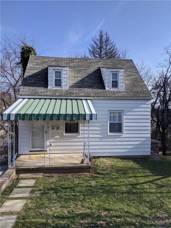 view of front facade with a front lawn and a standing seam roof