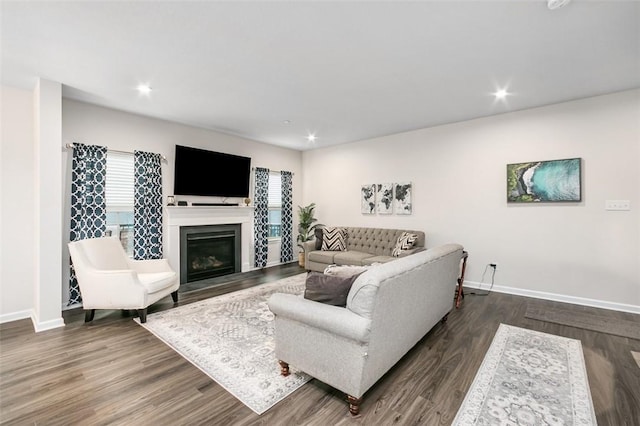 7005 Augusta Ln, Penn Twp Wml, PA 15644 - living area featuring baseboards, dark wood-style floors, a glass covered fireplace, and recessed lighting