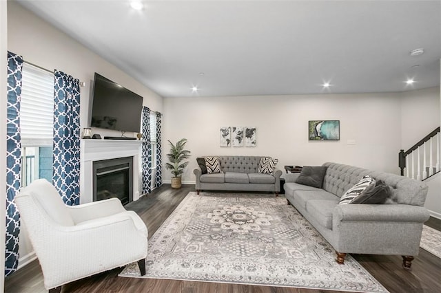 7005 Augusta Ln, Penn Twp Wml, PA 15644 - living area with wood finished floors, baseboards, a glass covered fireplace, recessed lighting, and stairs