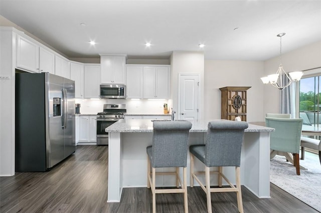 7005 Augusta Ln, Penn Twp Wml, PA 15644 - kitchen with appliances with stainless steel finishes, dark wood-type flooring, a chandelier, white cabinets, and an island with sink