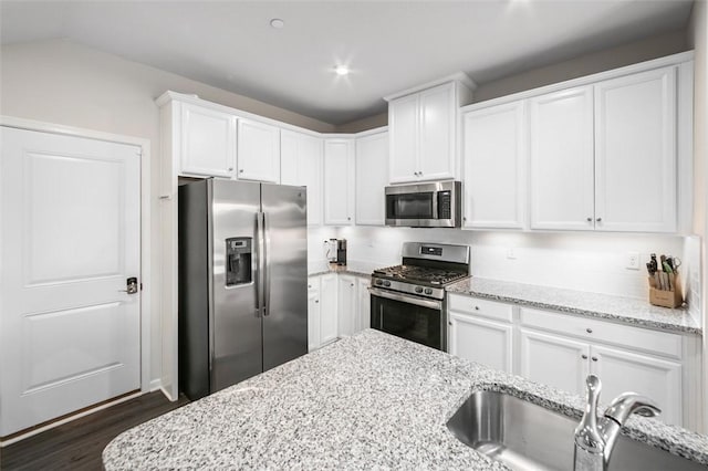 7005 Augusta Ln, Penn Twp Wml, PA 15644 - kitchen with stainless steel appliances, a sink, white cabinetry, dark wood finished floors, and light stone counters
