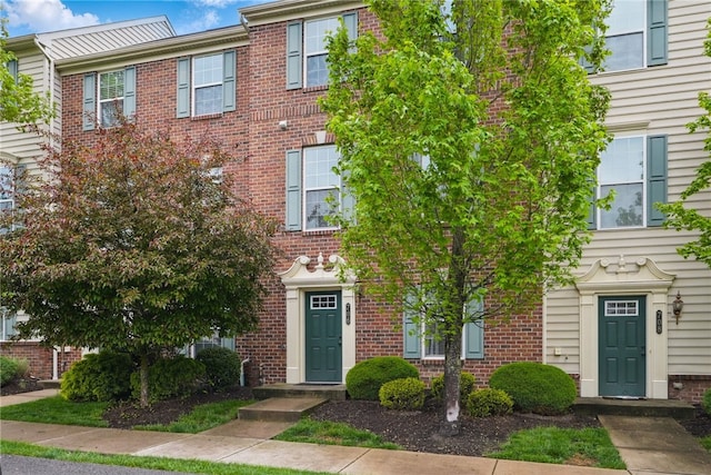 townhome / multi-family property with brick siding