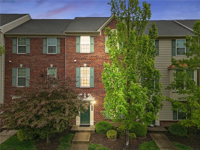 view of property featuring brick siding
