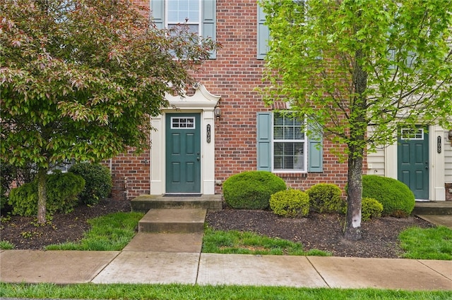 entrance to property with brick siding