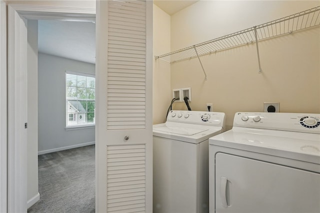 laundry room with separate washer and dryer, carpet, and baseboards