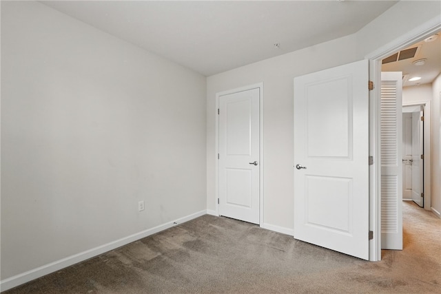 unfurnished bedroom with carpet and baseboards