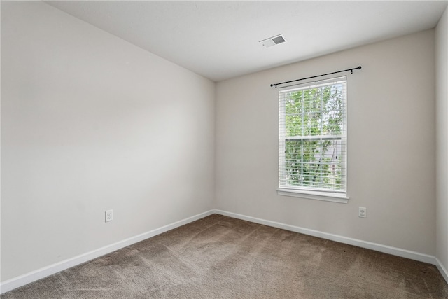 carpeted spare room with baseboards