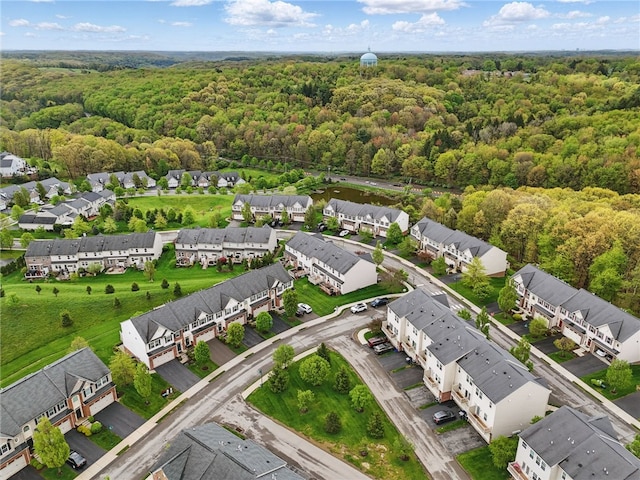 aerial view of residential area featuring a heavily wooded area