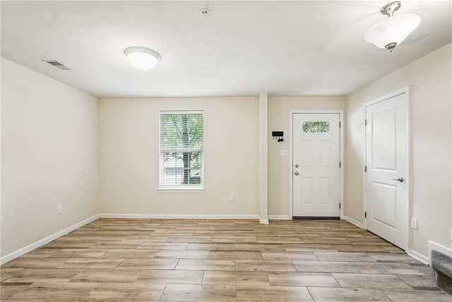entrance foyer with light wood-style flooring and baseboards