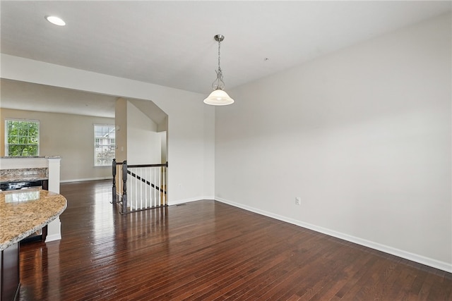 unfurnished room featuring dark wood-style flooring, baseboards, and recessed lighting