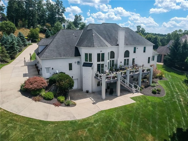 107 Mirage Dr, Cranberry Twp, PA 16066 - rear view of house with stucco siding, a shingled roof, a lawn, and a patio area