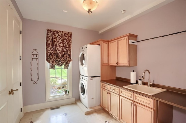 107 Mirage Dr, Cranberry Twp, PA 16066 - laundry room featuring stacked washer and clothes dryer, cabinet space, and baseboards