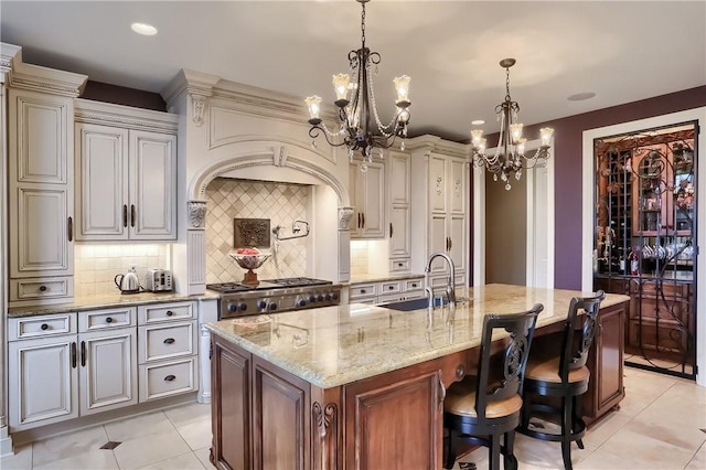 107 Mirage Dr, Cranberry Twp, PA 16066 - kitchen featuring a sink, a chandelier, light tile patterned flooring, light stone counters, and tasteful backsplash