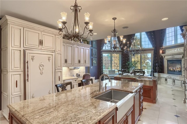 107 Mirage Dr, Cranberry Twp, PA 16066 - kitchen featuring a chandelier, a sink, a large island with sink, cream cabinets, and recessed lighting