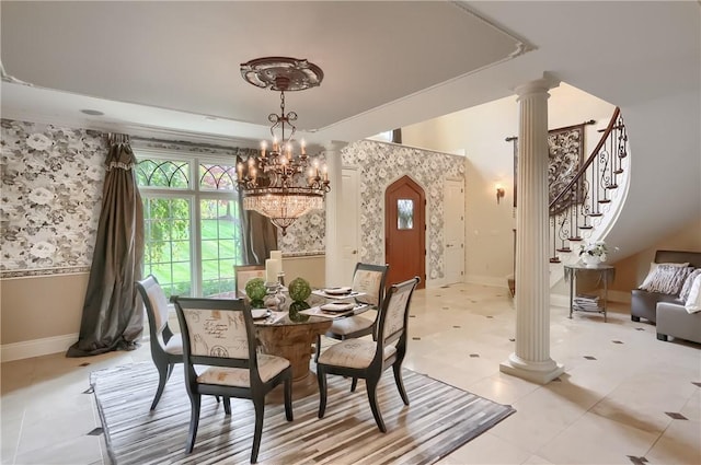 107 Mirage Dr, Cranberry Twp, PA 16066 - dining area featuring ornate columns, a raised ceiling, baseboards, a chandelier, and wallpapered walls